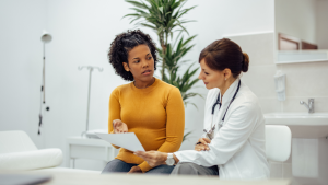 A woman talks with her health care provider